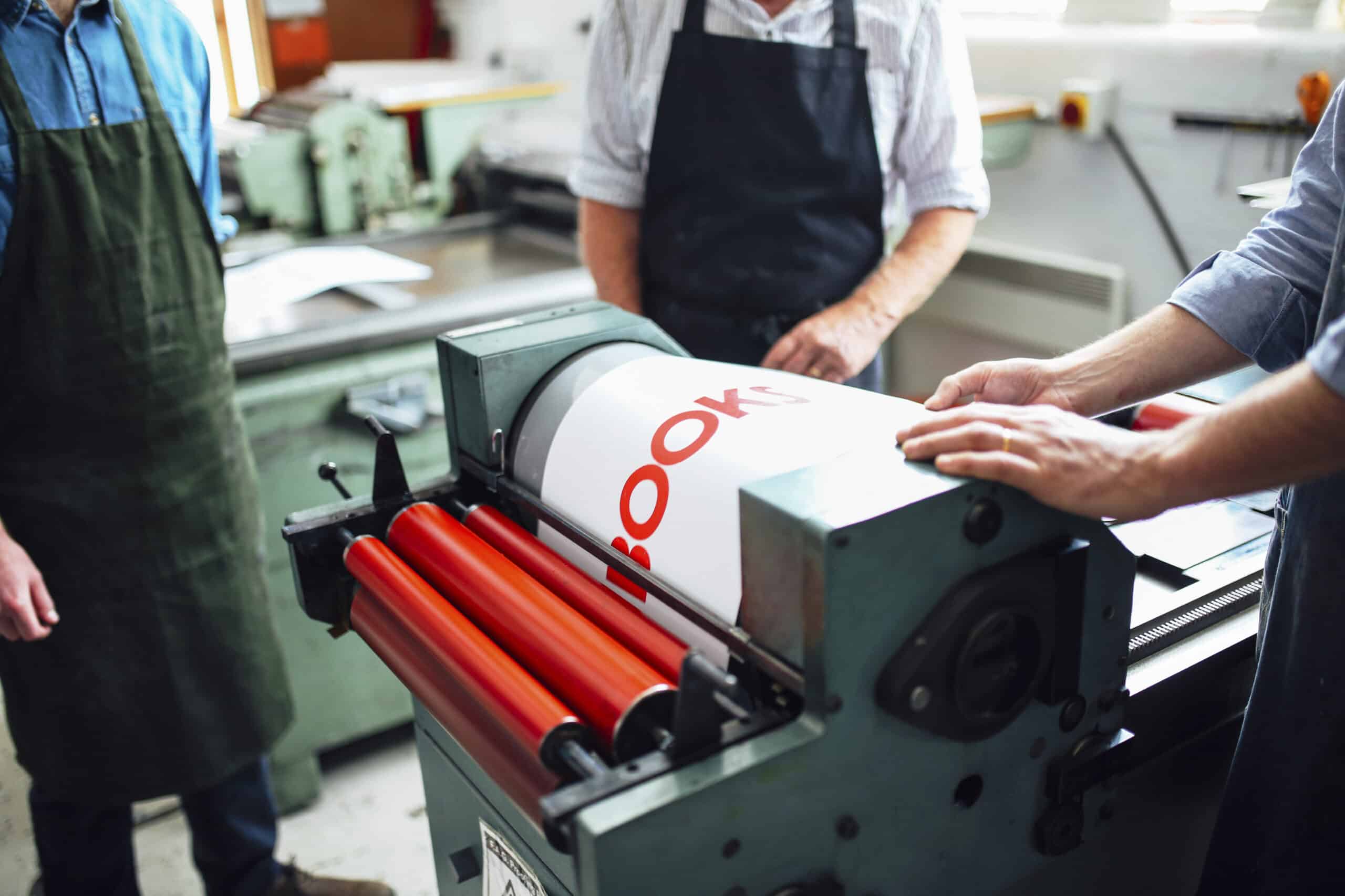 Custom Banners Printing Edmonton 13 Craftspeople being shown how to use letterpress machine in book arts workshop, mid section